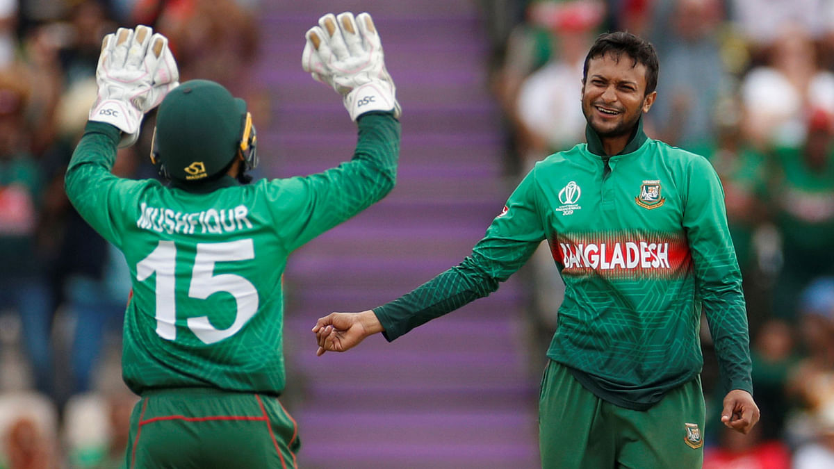 Bangladesh`s Shakib Al Hasan and Mushfiqur Rahim celebrate taking the wicket of Afghanistan`s Najibullah Zadran