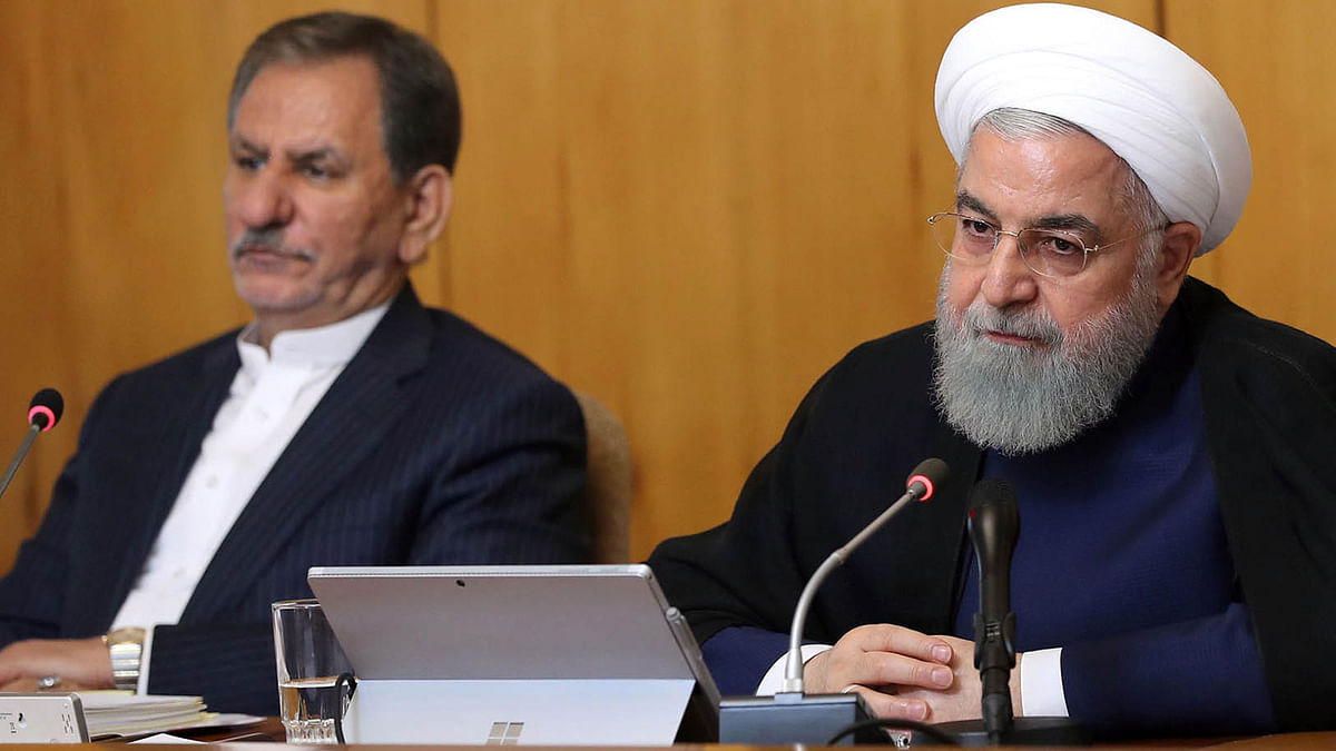 A handout picture provided by the Iranian presidency on 19 June shows president Hassan Rouhani (R) and Iran`s First vice president Eshaq Jahangiri (L) attending a cabinet meeting in Tehran. Photo: AFP