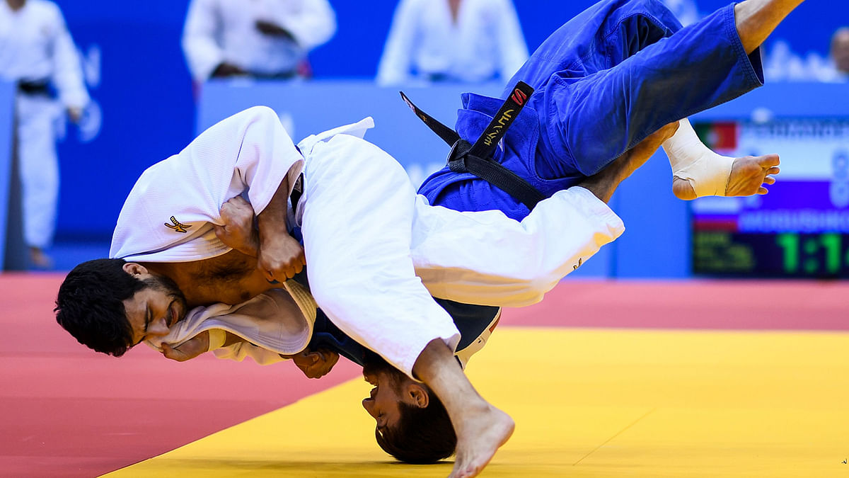 Portugal`s Jorge Fernandes (white) fights against Russia`s Musa Mogushkov in the mixed team judo tournament gold final at the 2019 European Games in Minsk on 25 June 2019. Photo: AFP