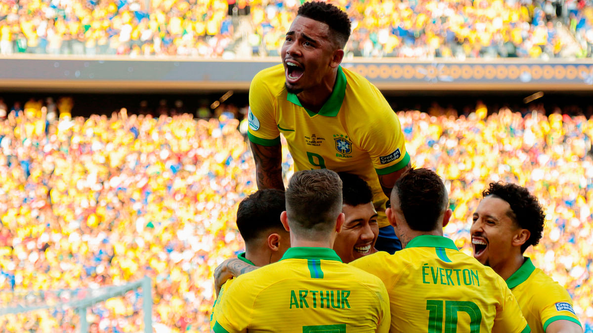 Brazil`s Roberto Firmino celebrates with teammates after scoring the team`s second goal against Peru during their Copa America football tournament group match at the Corinthians Arena in Sao Paulo, Brazil, on 22 June 2019. Photo: AFP