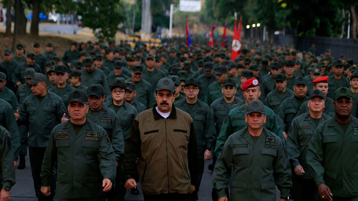 Venezuela`s president Nicolas Maduro walks next to Venezuela`s defence minister Vladimir Padrino Lopez and Remigio Ceballos, Strategic Operational Commander of the Bolivarian National Armed Forces, during a ceremony at a military base in Caracas, Venezuela on 2 May. Photo: Reuters