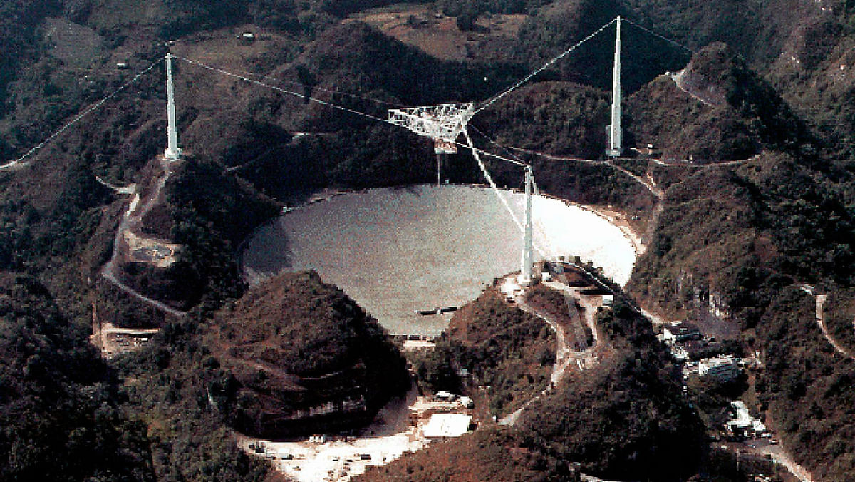 his undated file image obtained 2 July 2003, courtesy of NASA shows the Arecibo radio telescope in Puerto Rico. Photo: AFP