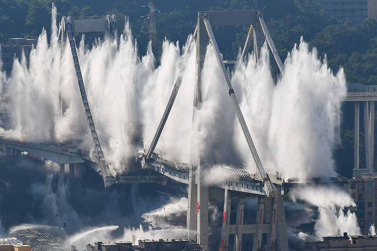 Explosive charges blow up the eastern pylons of Genoa`s Morandi motorway bridge on 28 June 2019 in Genoa. Photo: AFP