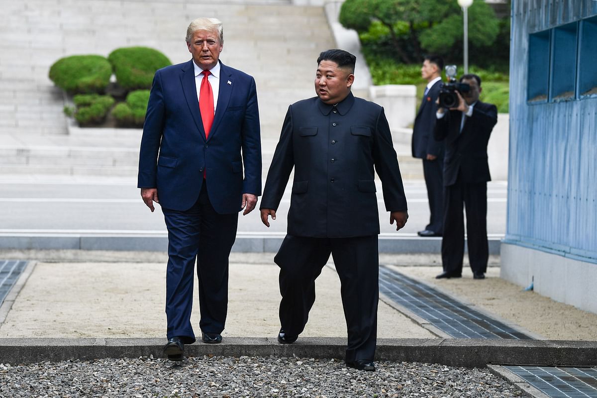 North Korea`s leader Kim Jong Un and US President Donald Trump cross south of the Military Demarcation Line that divides North and South Korea, after Trump briefly stepped over to the northern side, in the Joint Security Area (JSA) of Panmunjom in the Demilitarized zone (DMZ) on 30 June 2019. Photo: AFP