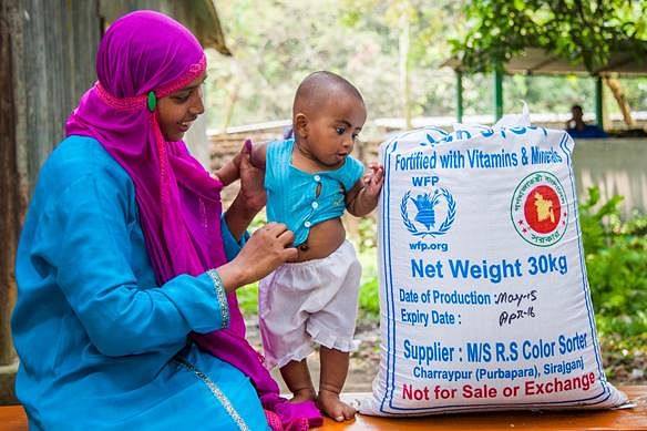 Woman and child with bag of fortified rice