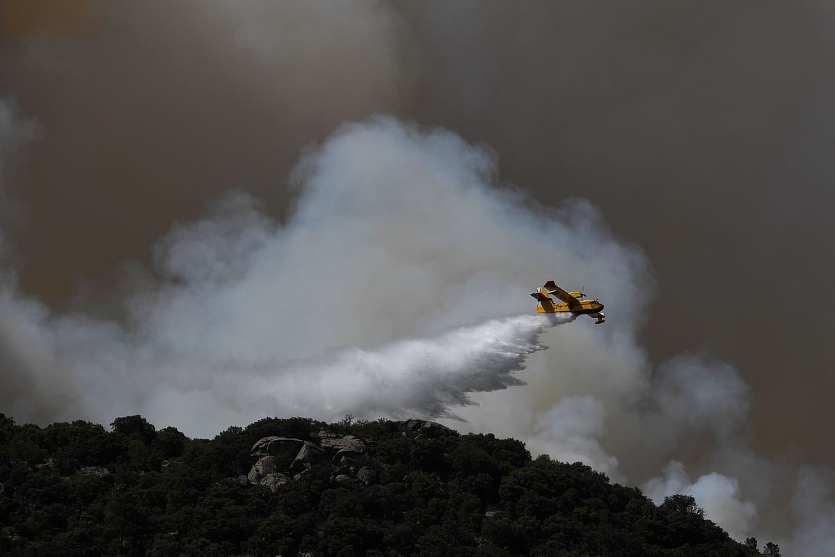 A Canadair drops water over a wildfire in the outskirts of Cenicientos in central Spain on 29 June. Photo: AFP