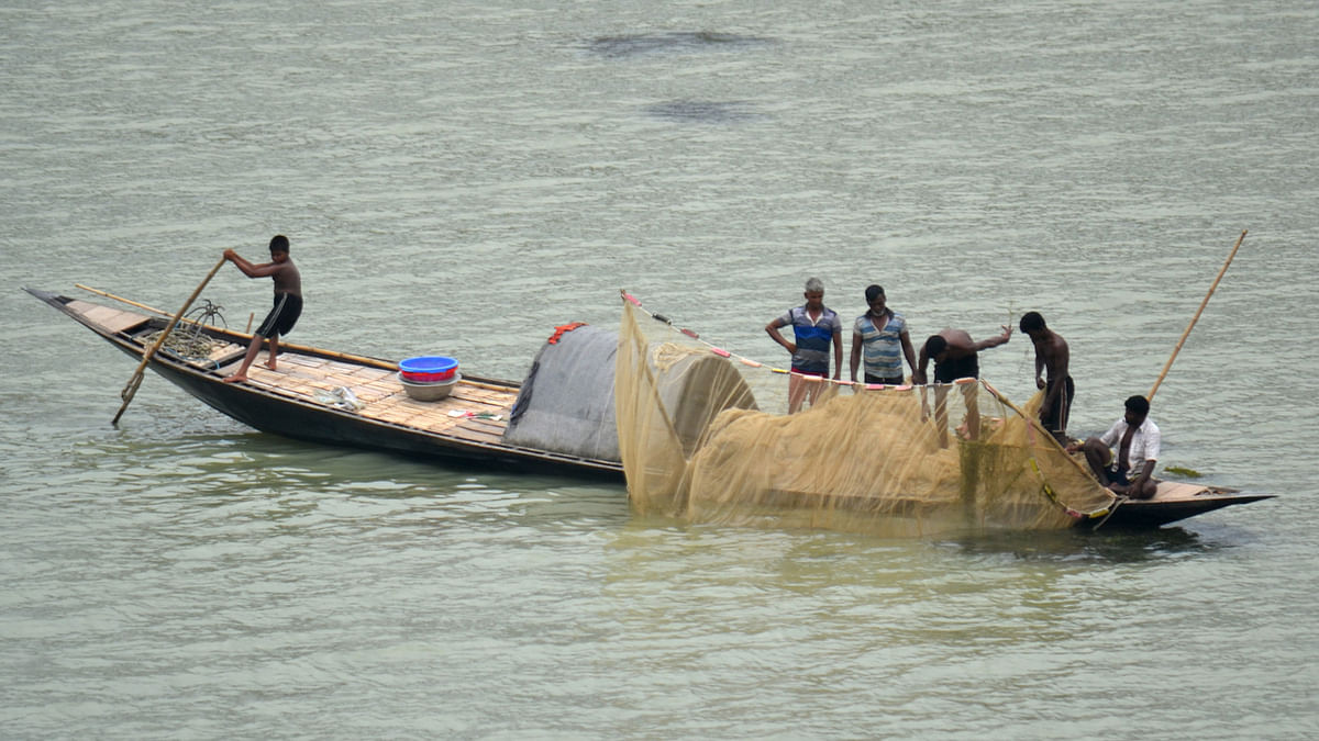 Fishermen rowing a boat to catch fish in Padma river in Pabna on 2 July, 2019. Photo:  Hasan Mahmud