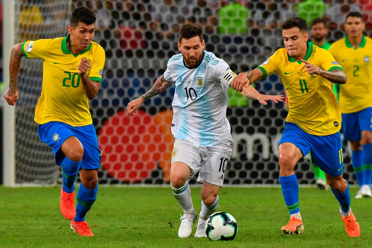 Argentina`s Lionel Messi (C) is marked by Brazil`s Roberto Firmino (L) and Philippe Coutinho during their Copa America football tournament semi-final match at the Mineirao Stadium in Belo Horizonte, Brazil, on 2 July 2019. Photo: AFP