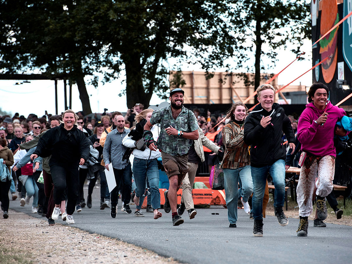 People run to secure a spot in front of the Orange stage during the Roskilde Festival 2019, Roskilde Denmark, 3 July 2019. Photo: Reuters