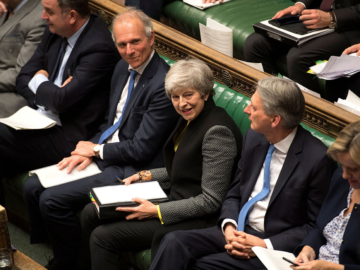 Britain`s prime minister Theresa May reacts as she listens to a speaker in Parliament in London, Britain on 3 July 2019. Photo: Reuters