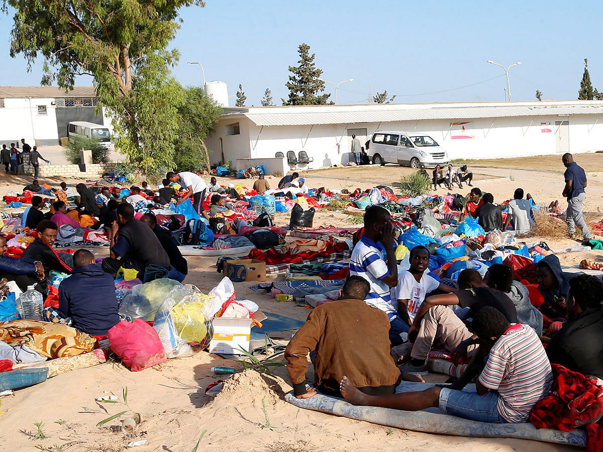 Migrants are seen with their belongings at the yard of a detention centre for mainly African migrants, hit by an airstrike, in the Tajoura suburb of Tripoli, Libya on 3 July 2019. Photo: Reuters