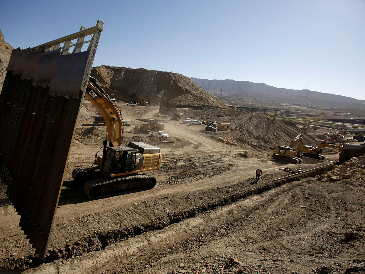 Heavy machinery moves a bollard-type wall, to be placed along the border of private property using funds raised from a GoFundMe account, at Sunland Park, N.M., as seen from Ciudad Juarez, Mexico on 27 May 2019. Reuters File Photo