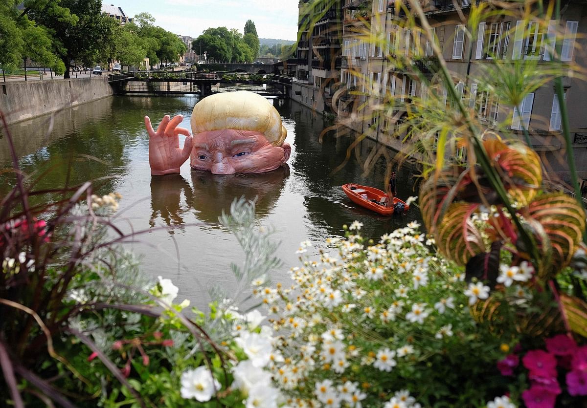 g is fine` depicting the half submerged head of US president Donald Trump by Jacques Rival, architect, displayed in the Moselle river as part of the digital art festival `Constellations de Metz` in Metz, eastern France. Photo: AFP