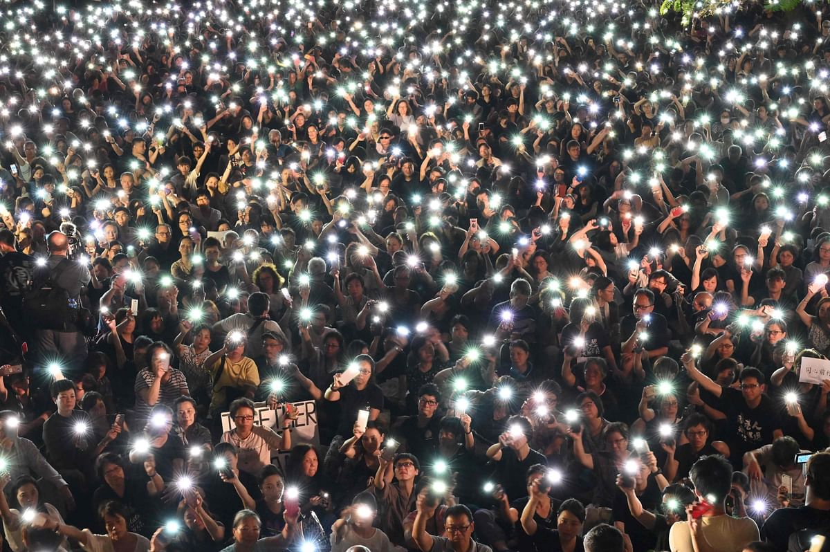 Demonstrators hold up lights from their phones during a rally organised by Hong Kong mothers in support of extradition law protesters, in Hong Kong on 5 July 2019. Photo: AFP