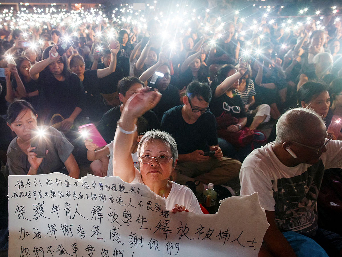 People wave flashlights during a gathering of Hong Kong mothers to show their support for the city’s young pro-democracy protesters in Hong Kong, China on 5 July. Photo: Reuters