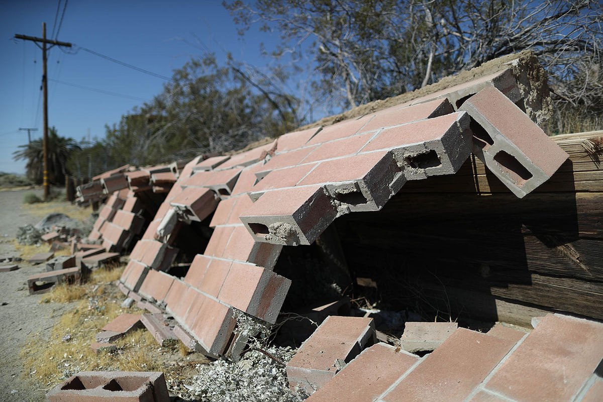 A cinder block wall is toppled after a 7.1 magnitude earthquake struck in the area on 6 July 2019 in Trona, California.