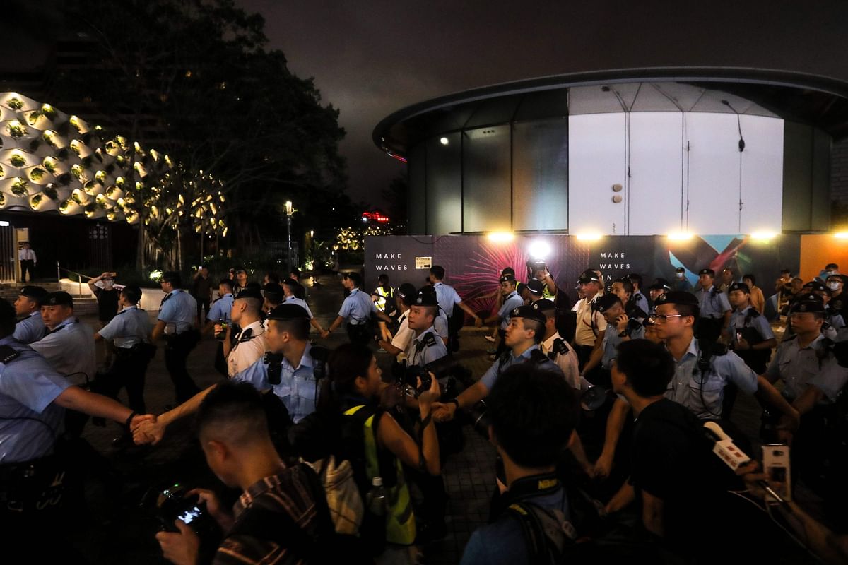 Protesters gather around as pro-democracy activist Joshua Wong confronts police after taking part in a march to the West Kowloon rail terminus against the proposed extradition bill in Hong Kong on 7 July, 2019. Photo: AFP