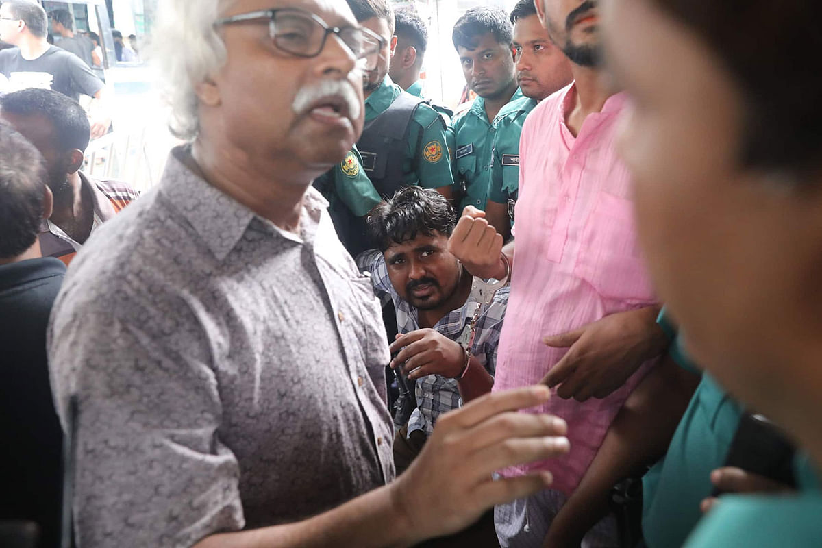 A leader of the Left Democratic Alliance (LDA) talks with a member of the law enforcement as they detain one of the protesters during a demonstration protesting against the recent hike in gas prices. Paltan, Dhaka on 7 July 2019. Photo: Saiful Islam
