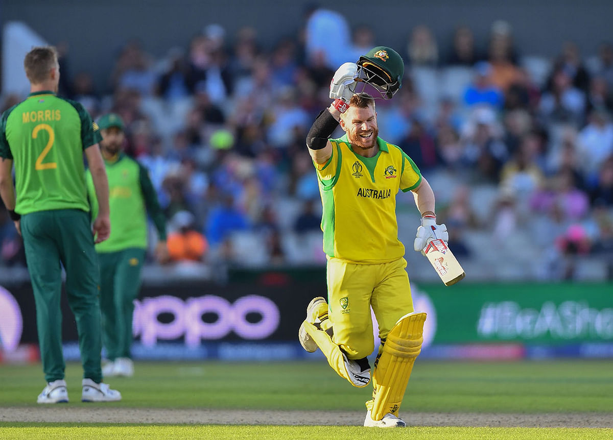 Australia`s David Warner celebrates after scoring a century (100 runs) during the 2019 Cricket World Cup group stage match between Australia and South Africa at Old Trafford in Manchester, northwest England, on 6 July 2019. Photo: AFP