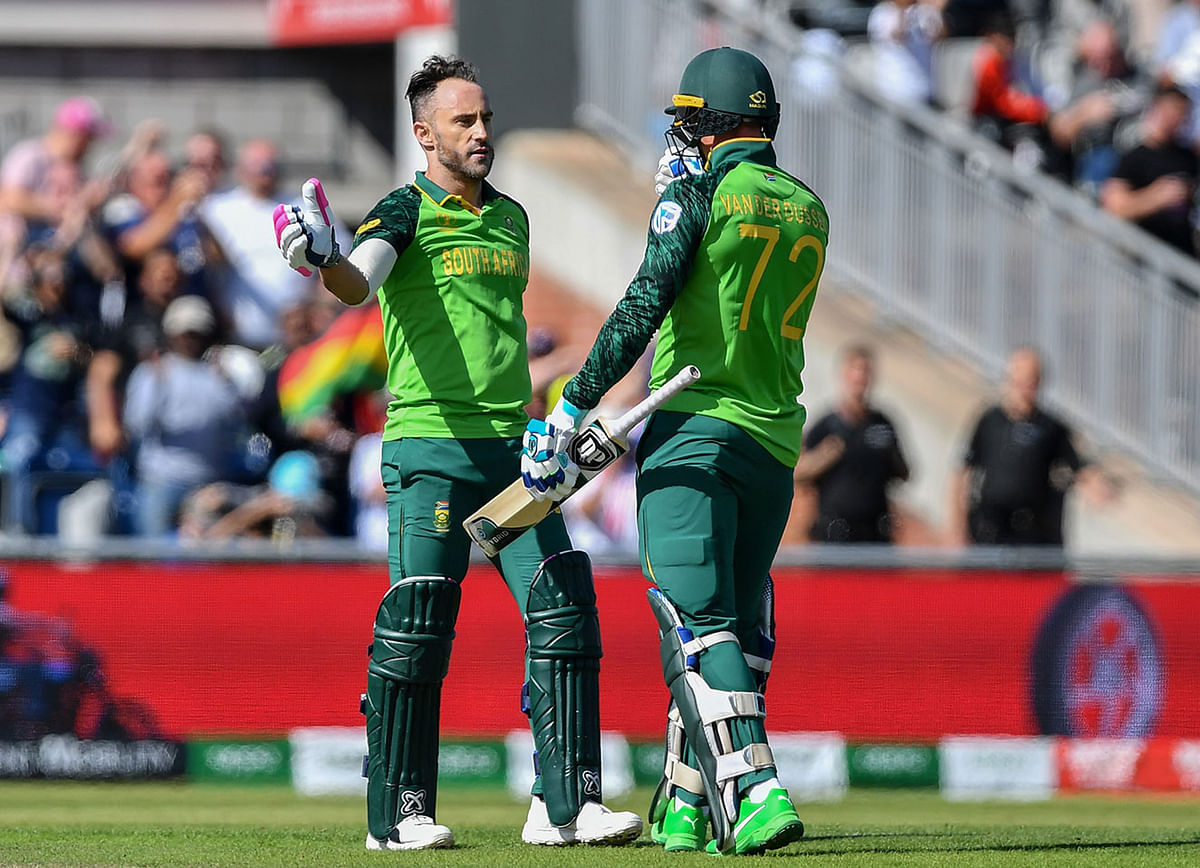 South Africa`s captain Faf du Plessis (L) celebrates with teammate Rassie van der Dussen after scoring a century (100 runs) during the 2019 Cricket World Cup group stage match between Australia and South Africa at Old Trafford in Manchester, northwest England, on 6 July 2019. Photo: AFP