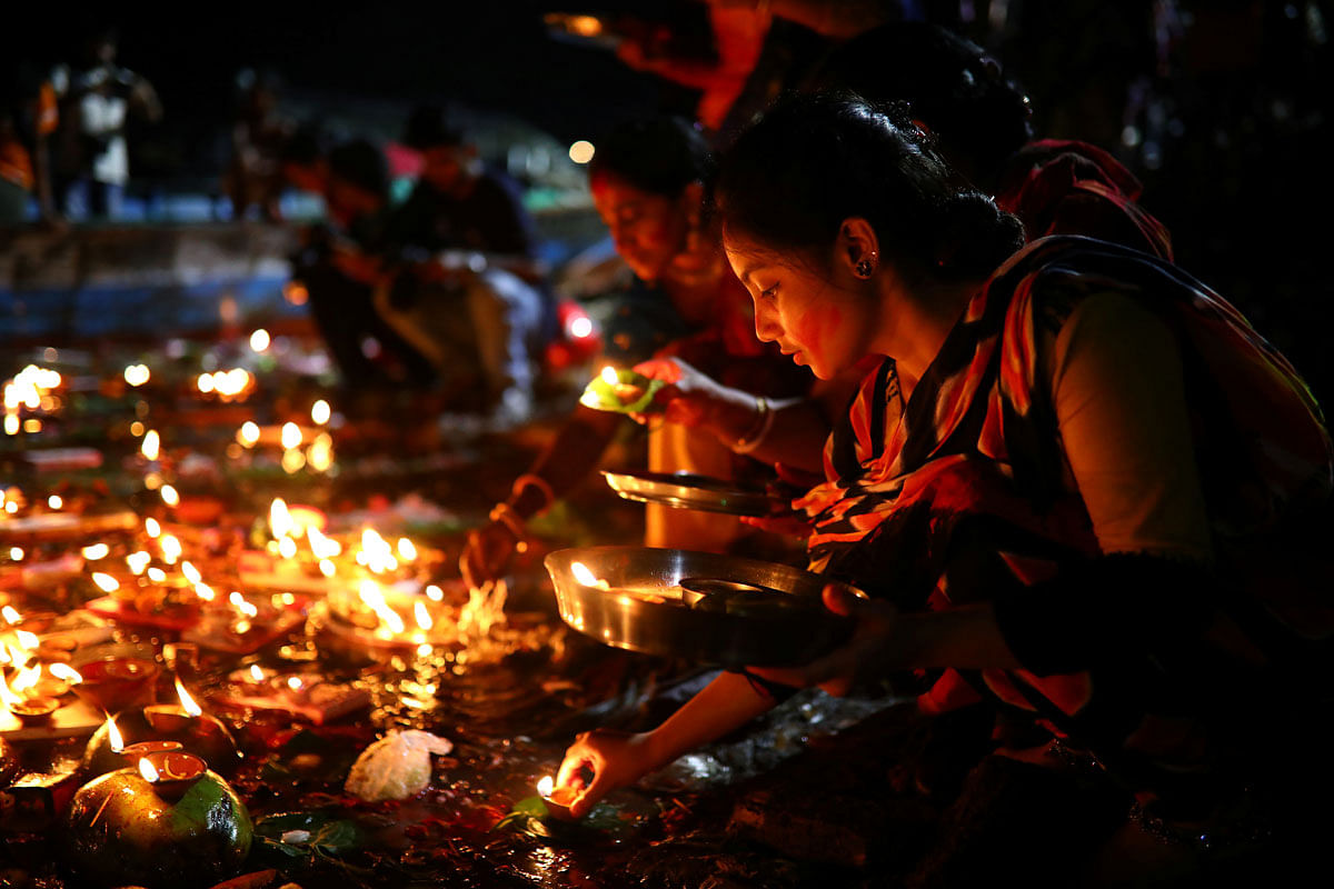Hindu devotees release oil lamps to the Buriganga river as they observe Bipottarini Puja in Dhaka, Bangladesh, 6 July 2019. Photo: Reuters