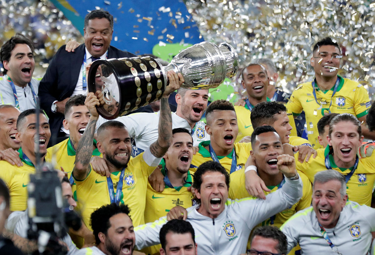 Brazil`s Dani Alves lifts the trophy as they celebrate winning the Copa America at Maracana Stadium in Rio de Janeiro, Brazil on 7 July, 2019. Photo: Reuters