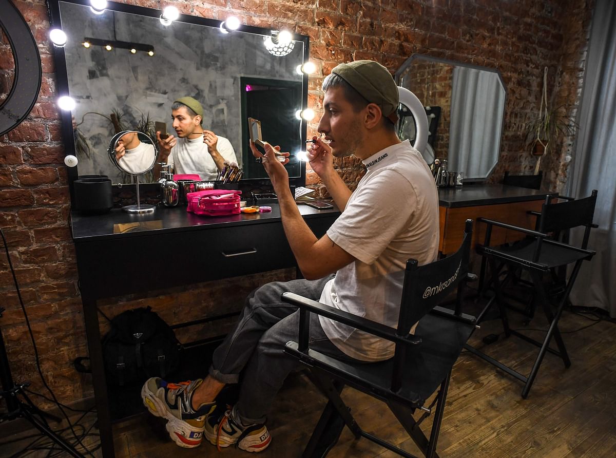 Beauty blogger Gevorg, 26, puts makes on his face as he attends an interview with AFP at a Moscow salon on 14 June 2019. Photo: AFP