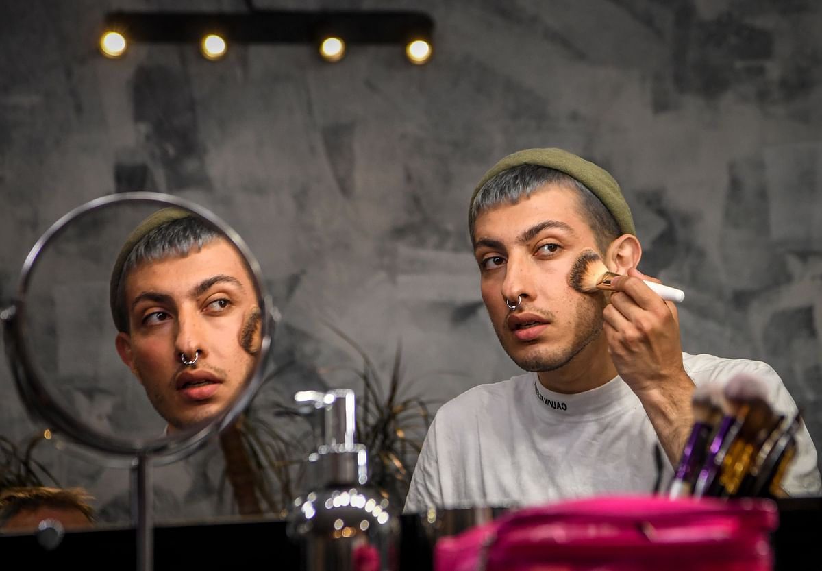 Beauty blogger Gevorg, 26, puts makes on his face as he attends an interview with AFP at a Moscow salon on 14 June 2019. Photo: AFP