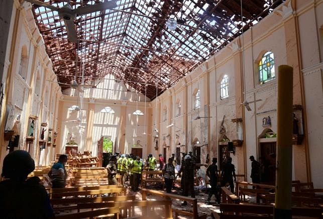 Crime scene officials inspect the site of a bomb blast inside a church in Negombo, Sri Lanka 21 April, 2019. Photo: Reuters