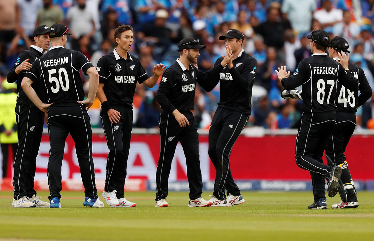 New Zealand`s Kane Williamson celebrates with Trent Boult and team mates after taking a catch to dismiss India`s Ravindra Jadeja in the ICC Cricket World Cup Semi-final match at Old Trafford, Manchester, Britain on 10 July 2019. Photo: Reuters