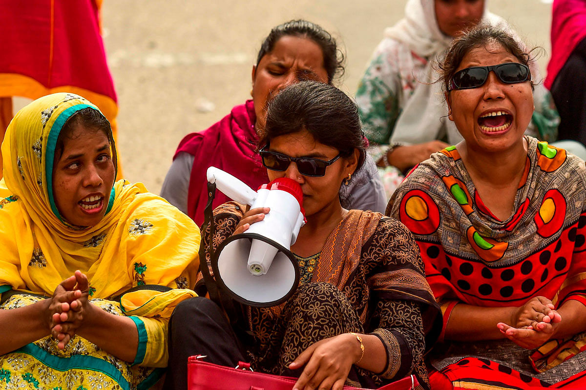 Bangladeshi visually challenged graduate personnel shout slogans as they sit to block a road during a protest in front of the National Parliament in Dhaka on 10 July 2019, to request jobs according to their qualification. Photo: AFP
