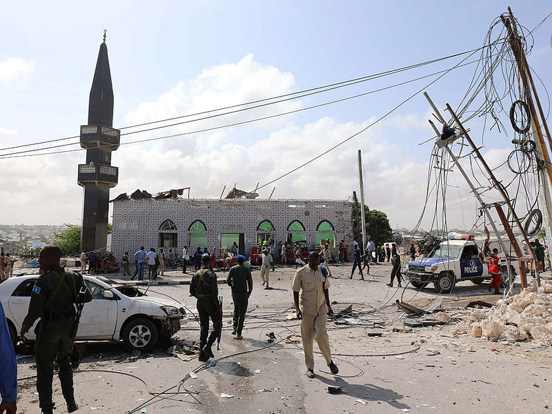 Somali security officers secure the scene of a suicide car explosion at a checkpoint near the Somali Parliament building in Mogadishu, Somalia on 15 June. Reuters File Photo