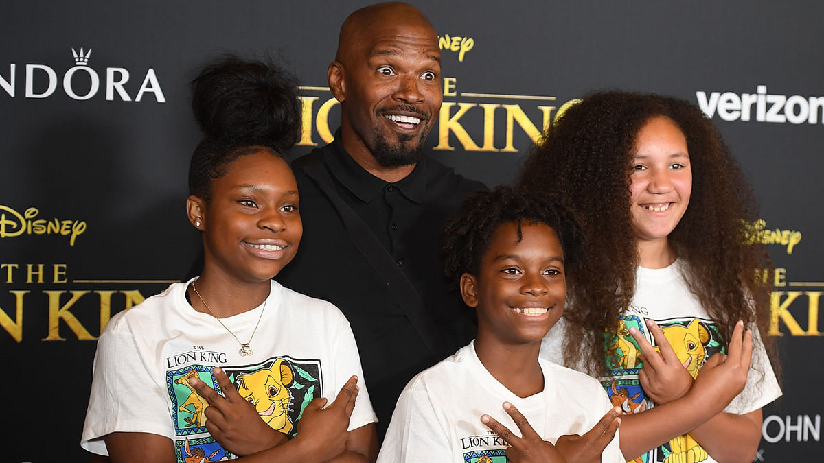 US actor Jamie Foxx (C), daughter Anelise (R) and friends arrive for the world premiere of Disney`s `The Lion King` at the Dolby theatre on 9 July 2019 in Hollywood. Photo: AFP