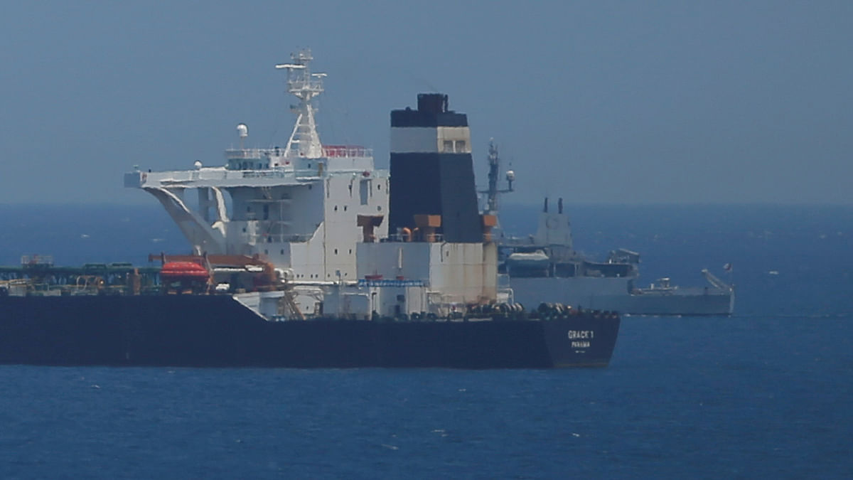 A British Royal Navy patrol vessel guards the oil supertanker Grace 1, that`s on suspicion of carrying Iranian crude oil to Syria, as it sits anchored in waters of the British overseas territory of Gibraltar, historically claimed by Spain on 4 July. Photo: Reuters