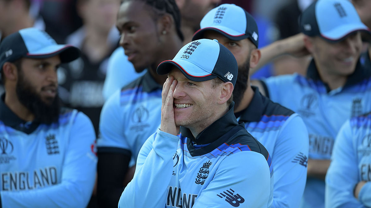 England`s captain Eoin Morgan reacts as England`s players celebrate their win after the 2019 Cricket World Cup final between England and New Zealand at Lord`s Cricket Ground in London on 14 July, 2019. Photo: AFP