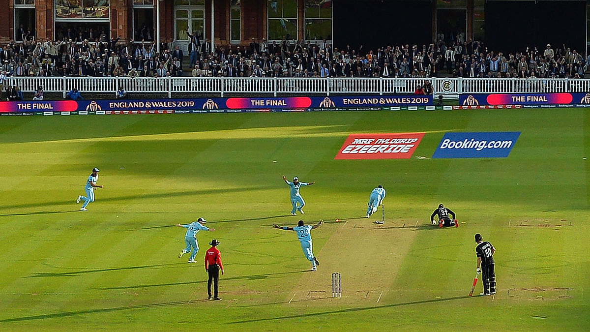 England`s Jos Buttler runs out New Zealand`s Martin Guptill to win the super-over to win the 2019 Cricket World Cup final between England and New Zealand at Lord`s Cricket Ground in London on 14 July 2019. Photo: AFP