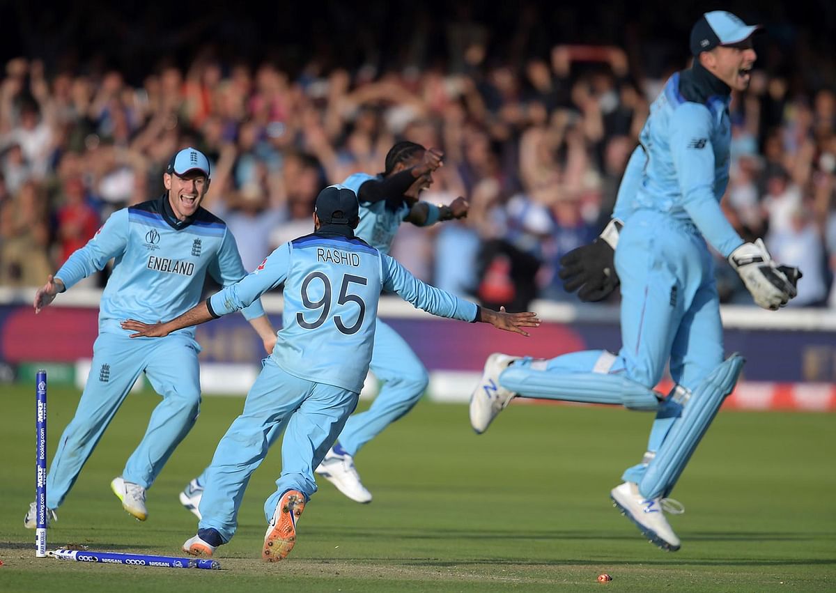 England`s captain Eoin Morgan (L) celebrates with his players after victory in the 2019 Cricket World Cup final between England and New Zealand at Lord`s Cricket Ground in London on July 14, 2019. AFP