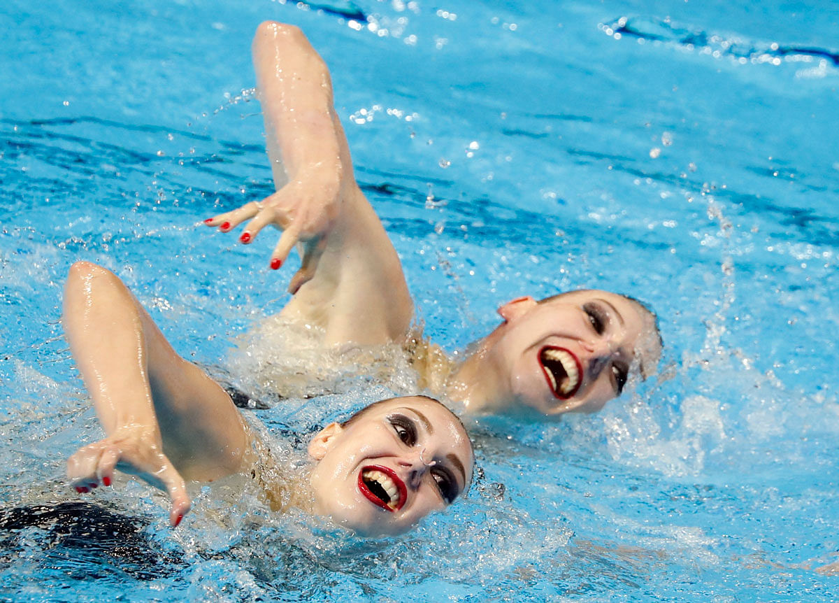 Svetlana Kolesnichenko and Svetlana Romashina of Russia compete on 16 July. Photo: Reuters