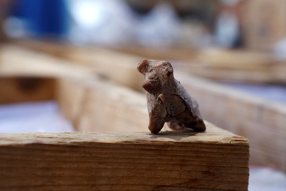 A figurine, part of findings uncovered at a huge prehistoric settlement discovered by Israeli archaeologists, is seen at the excavation site in the town of Motza near Jerusalem on 16 July 2019. Photo: Reuters