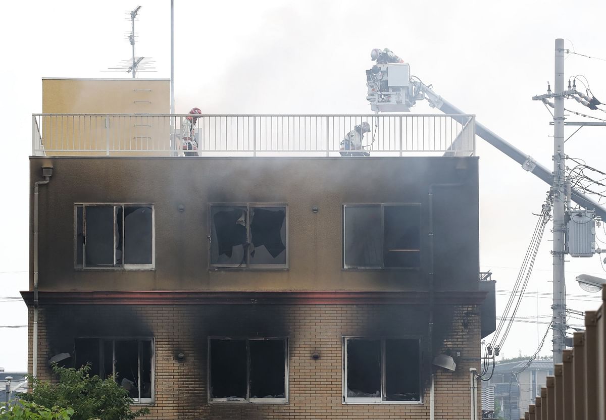 Firefighters and rescue personnel search an animation company building after a fire broke out in Kyoto on 18 July 2019. Photo: AFP