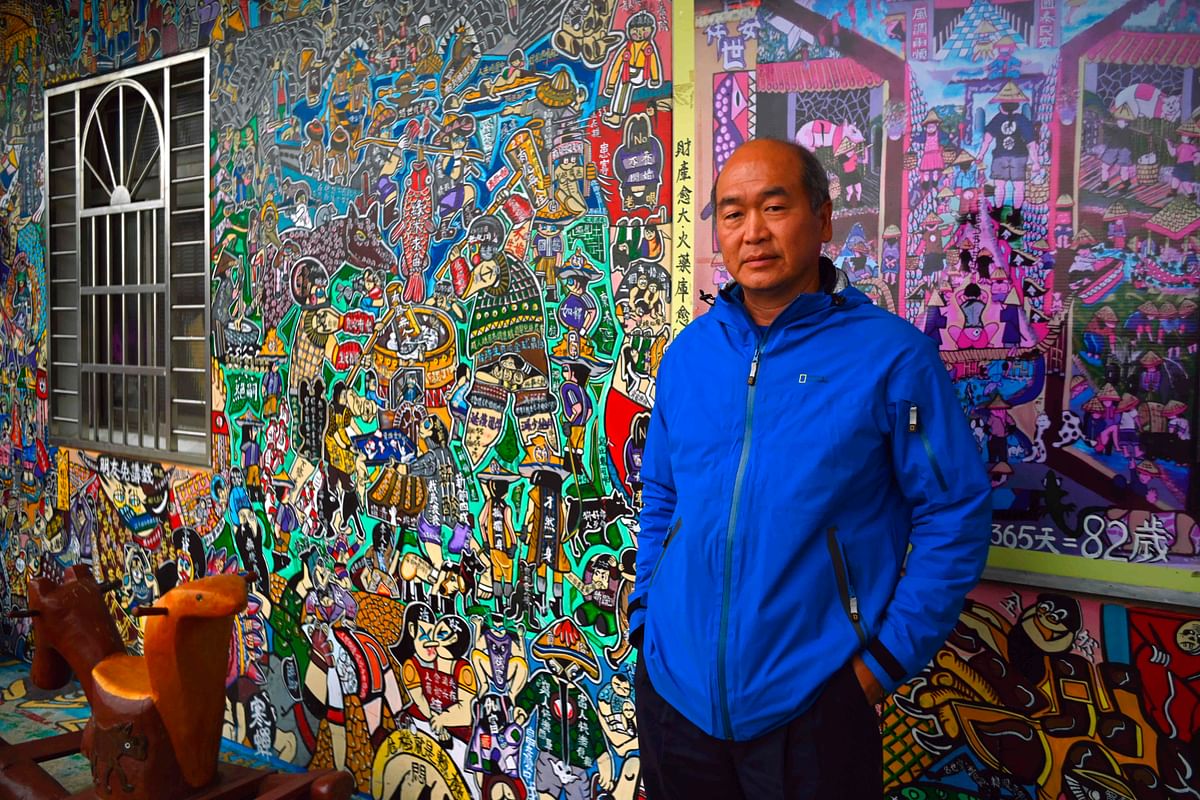 This picture taken on 30 March 2019 shows Hakka graffiti artist Wu Tsun-hsien posing for photos at his home in the Taiwanese village of Ruan Chiao. Photo: AFP