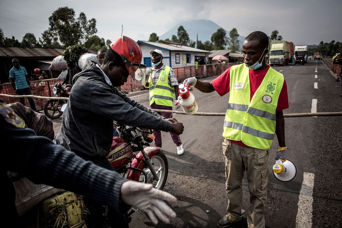 A motor taxi driver gets his hands washed at an Ebola screening station on the road between Butembo and Goma on 16 July 2019 in Goma. Photo: AFP