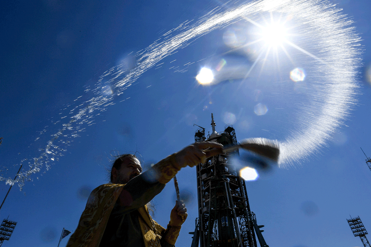 A Russian Orthodox priest blesses the Soyuz MS-13 spacecraft at the launch pad of the Russian-leased Baikonur cosmodrome on 19 July, 2019. Photo: AFP