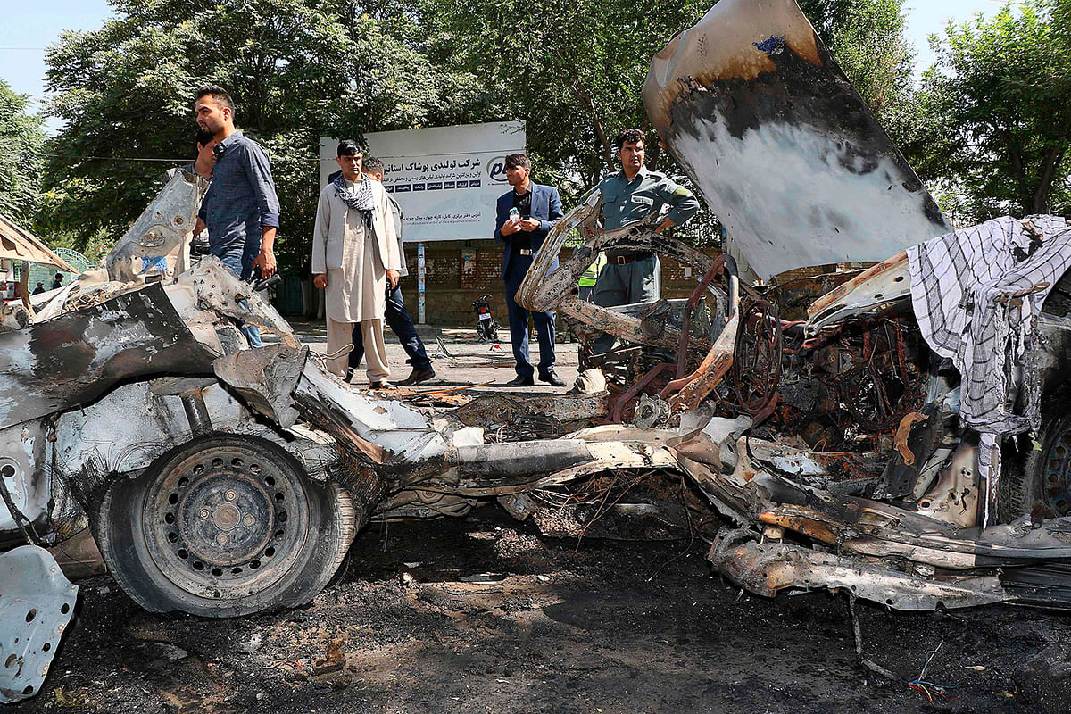 Afghans security personnel investigate at the site of a bomb explosion in front of Kanul University in Kabul on 19 July. Photo: AFP