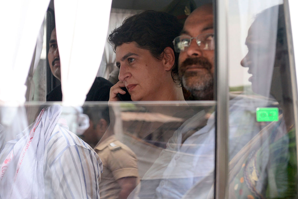 In this handout photo taken and released by the All India Congress Committee (AICC) Communication Department on 19 July 2019, Indian politician Priyanka Gandhi Vadra (C) looks on as she is taken in an official vehicle after being arrested at Narayanpur district, Mirzapur. Photo: AFP