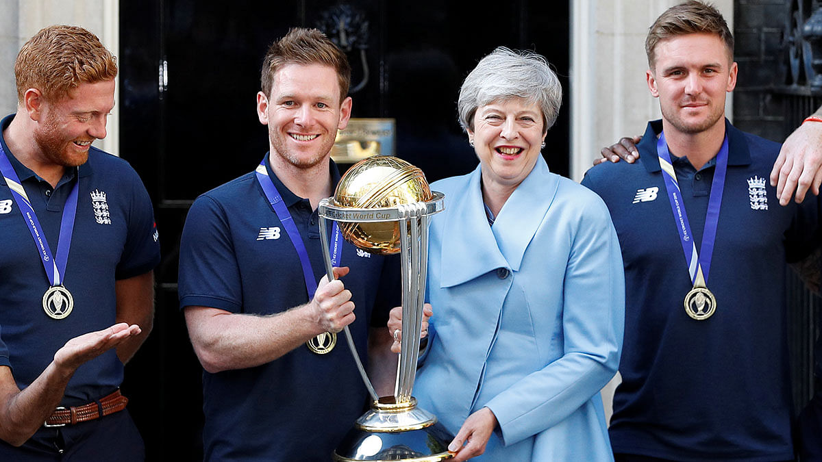 England`s Eoin Morgan and Britain`s prime minister Theresa May with the trophy as they pose with the team outside number 10 Downing Street, London, Britain on 15 July 2019. Reuters File Photo