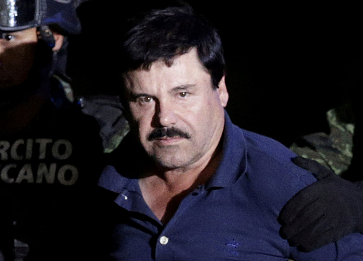 Recaptured drug lord Joaquin `El Chapo` Guzman is escorted by soldiers at the hangar belonging to the office of the attorney general in Mexico City, Mexico on 8 January 2016. Photo: Reuters