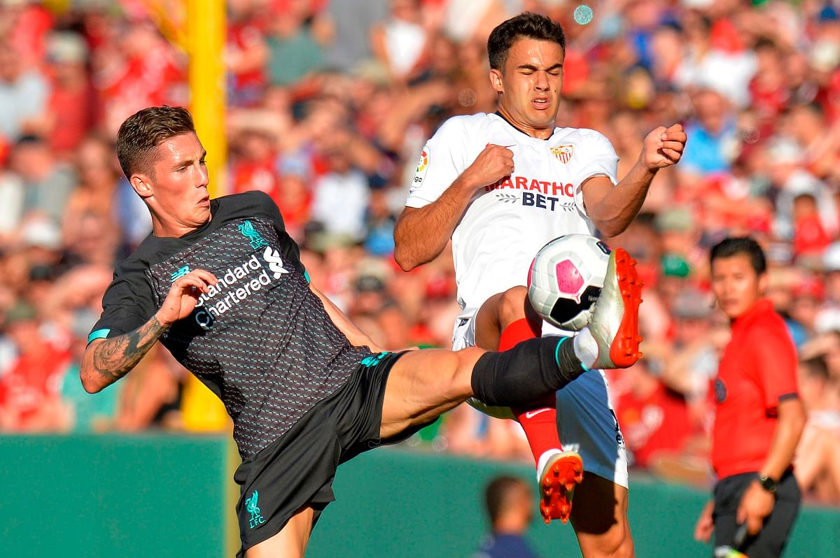 Liverpool`s Harry Wilson (L) and Sevilla`s Rodriguez Sergio Reguilon fight for the ball during a pre-season friendly match between Liverpool FC and Sevilla FC at Fenway Park in Boston on 21 July, 2019. Photo: AFP