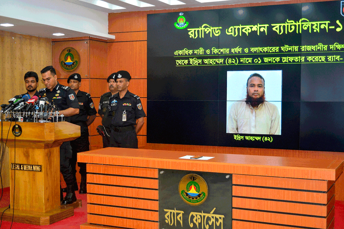 In this handout photo taken and released by the Bangladesh elite police Rapid Action Battalion (RAB) on 22 July 2019, RAB officers speak at a press conference about Idris Ahmed (R), a cleric arrested for allegedly raping a dozen boys, in Dhaka on 22 July 2019. Photo: AFP