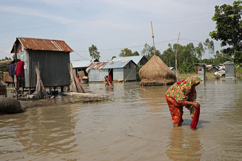 A flood-affected woman is seen washing her clothes in Jamalpur, Bangladesh, on 21 July 2019. Photo: Reuters